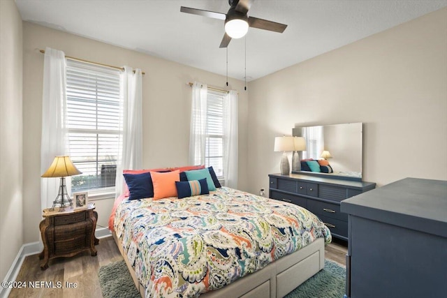 bedroom featuring ceiling fan and dark hardwood / wood-style floors