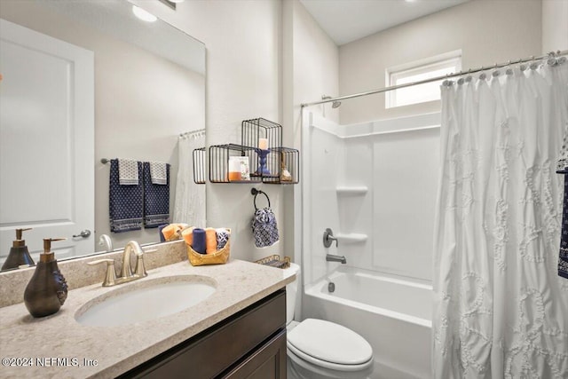 full bathroom featuring shower / bathtub combination with curtain, vanity, and toilet