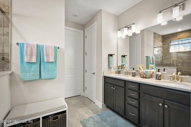 bathroom featuring tile patterned flooring, vanity, and a shower with shower door