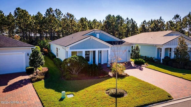 view of front of house with a garage and a front yard