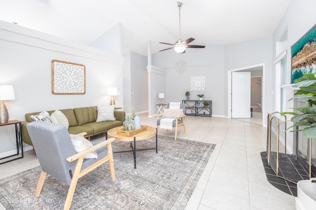 living room featuring ceiling fan, light tile patterned floors, and high vaulted ceiling