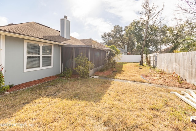 view of yard featuring a sunroom