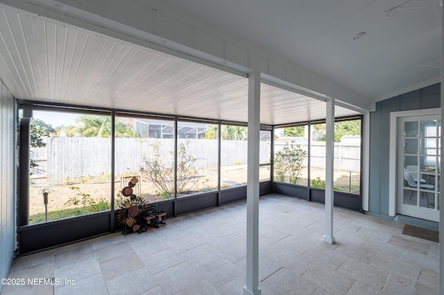 unfurnished sunroom with lofted ceiling