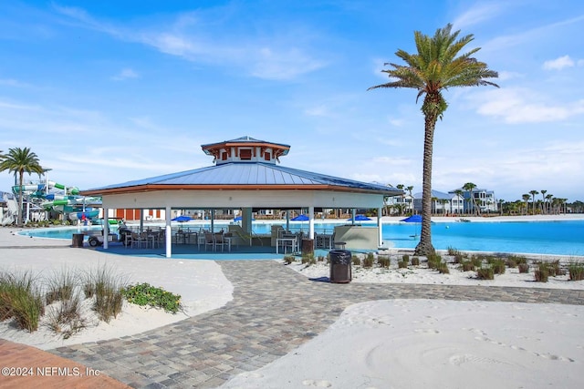 view of pool with a gazebo and a water view