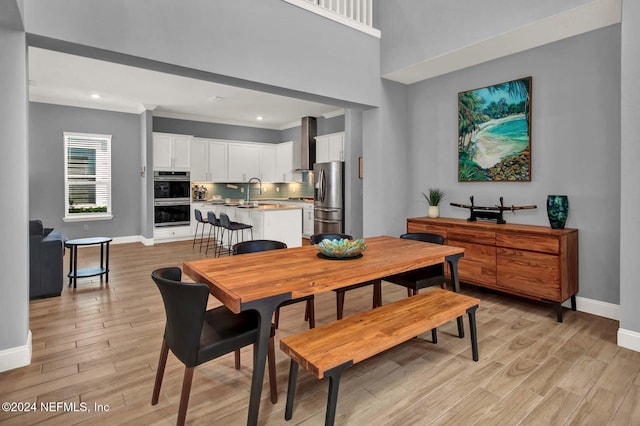 dining area with light wood-type flooring and sink