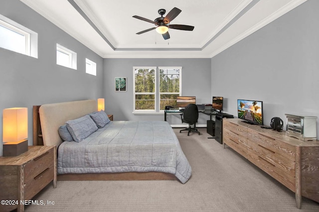 bedroom featuring a raised ceiling, ceiling fan, light colored carpet, and ornamental molding