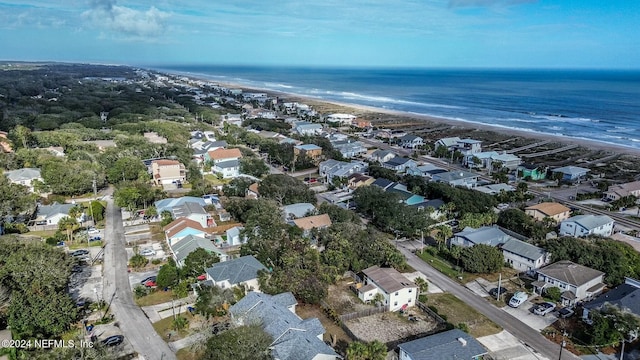 bird's eye view featuring a water view and a beach view