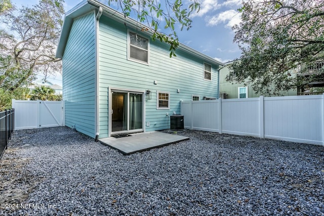 back of property featuring a patio and central AC