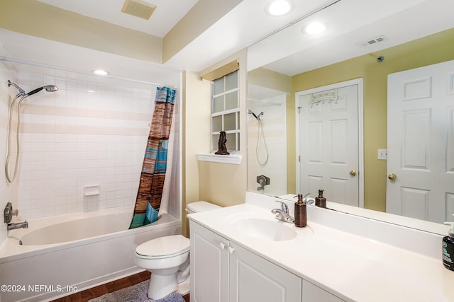 full bathroom featuring hardwood / wood-style floors, vanity, shower / tub combo, and toilet