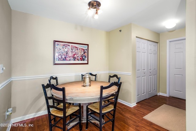 dining room with dark hardwood / wood-style flooring