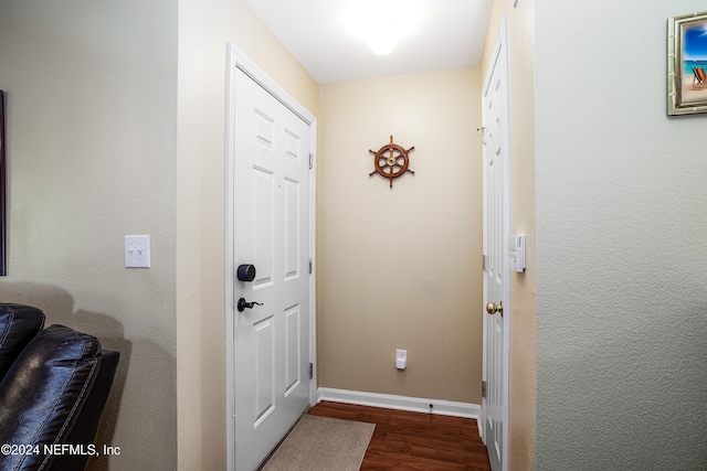 entryway with dark hardwood / wood-style flooring