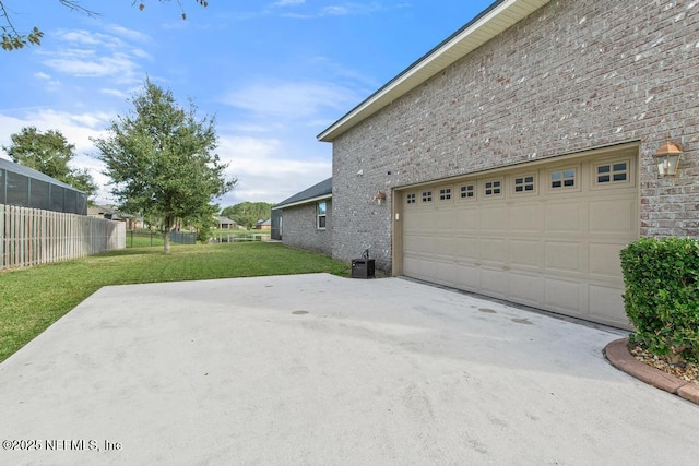 garage featuring a yard and central AC unit