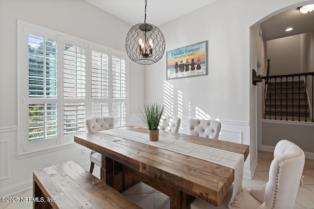 tiled dining space with a notable chandelier