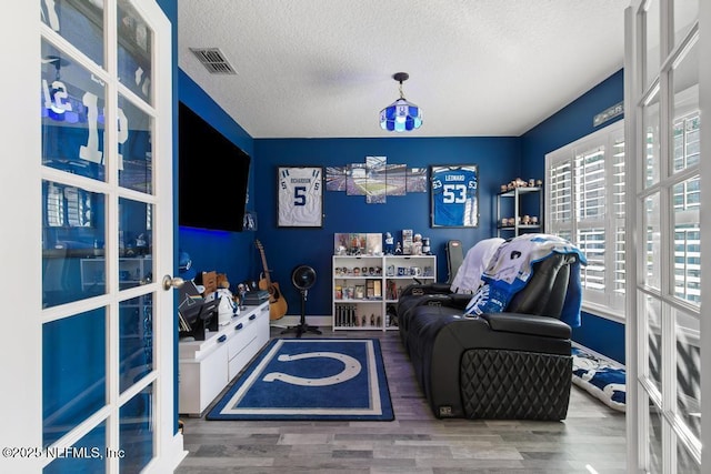 interior space with hardwood / wood-style floors and a textured ceiling