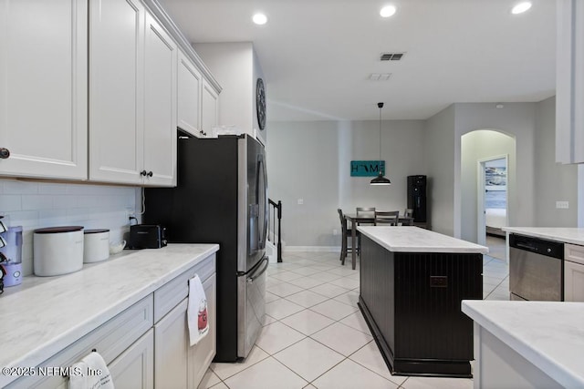 kitchen featuring white cabinetry, pendant lighting, light tile patterned floors, and stainless steel appliances