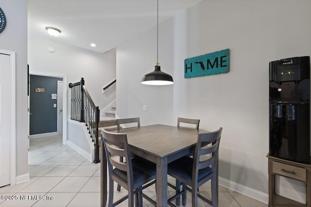 dining room with light tile patterned floors and lofted ceiling