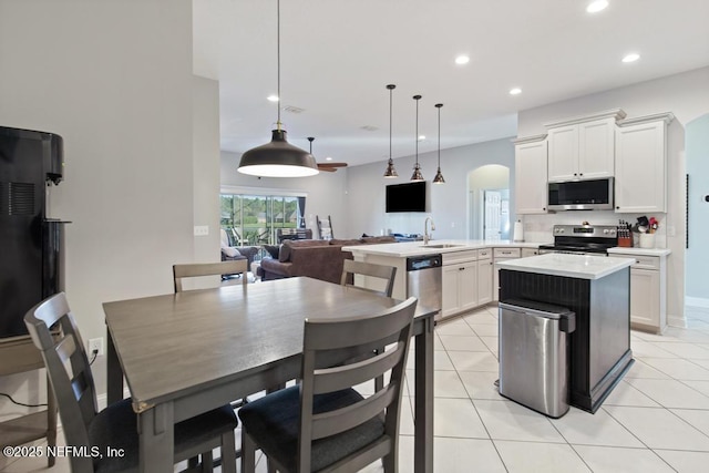 kitchen with pendant lighting, white cabinetry, sink, and appliances with stainless steel finishes