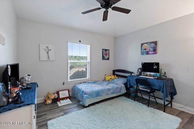 bedroom with ceiling fan and dark hardwood / wood-style flooring