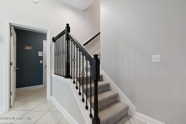 stairway with tile patterned floors