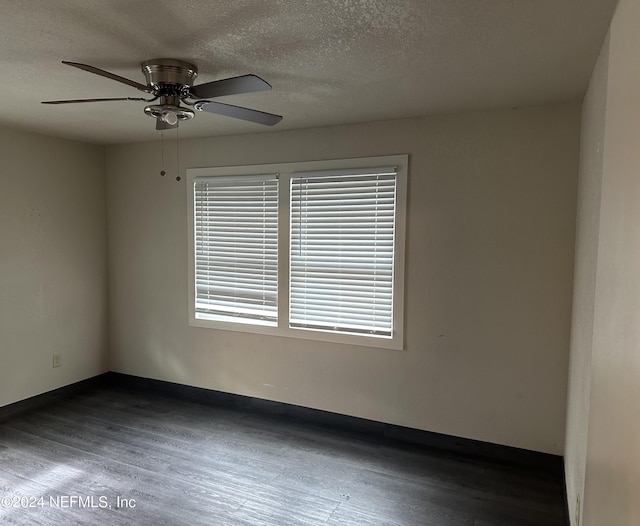 spare room featuring ceiling fan, dark hardwood / wood-style flooring, and a textured ceiling