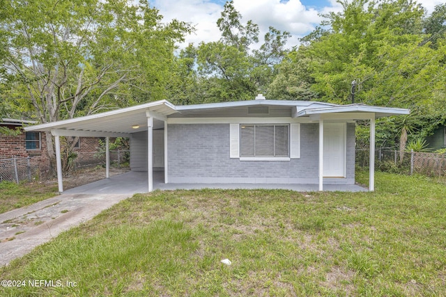 single story home with a carport and a front lawn