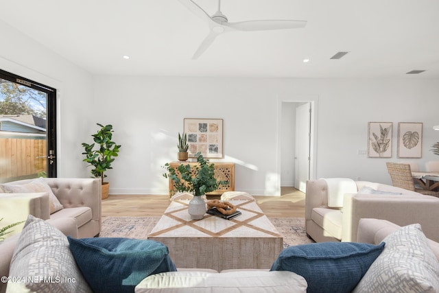 living room with ceiling fan and light hardwood / wood-style floors