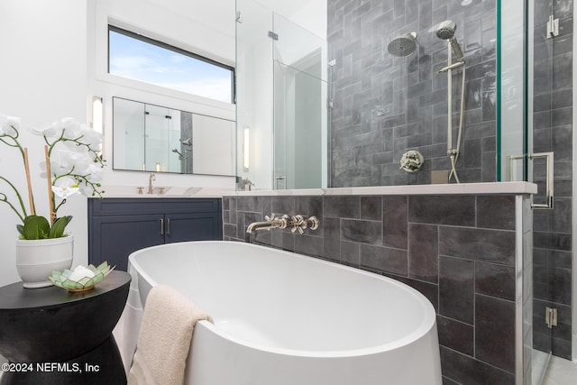 bathroom featuring separate shower and tub and vanity