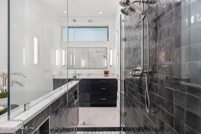 bathroom featuring tiled shower, vanity, and tile patterned floors