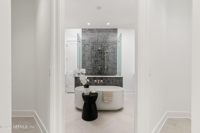 bathroom with tile patterned flooring and separate shower and tub