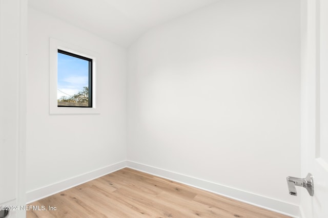 empty room featuring light hardwood / wood-style floors and lofted ceiling