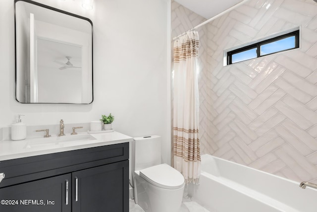 full bathroom with toilet, vanity, shower / tub combo with curtain, and ceiling fan