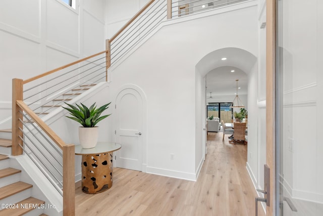 interior space featuring a high ceiling and hardwood / wood-style flooring