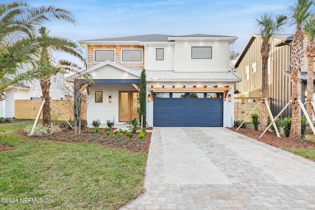 view of front of property with a front yard and a garage