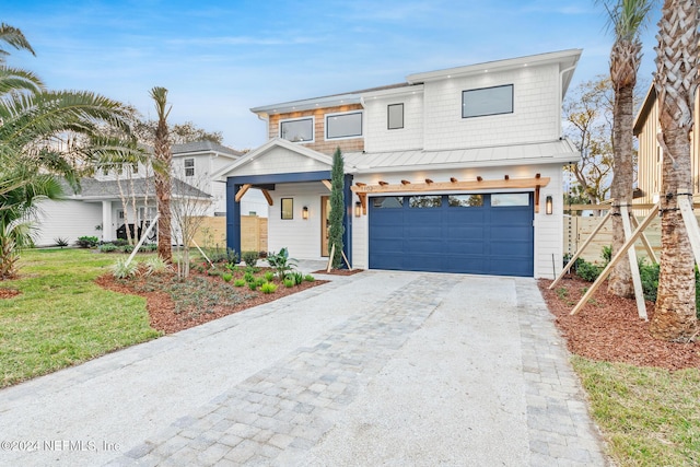 view of front of house with a front yard and a garage