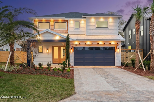 view of front facade with a garage and a lawn