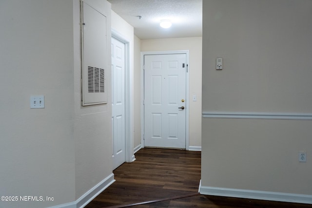 doorway featuring dark hardwood / wood-style flooring and a textured ceiling