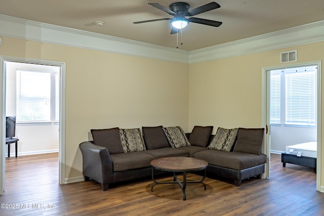 living room with ceiling fan, wood-type flooring, and crown molding