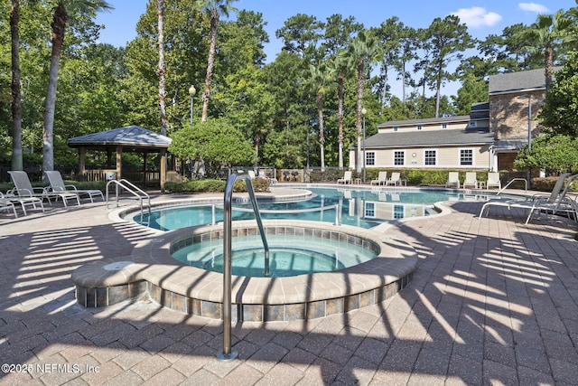 view of pool with a gazebo, a patio area, and a community hot tub