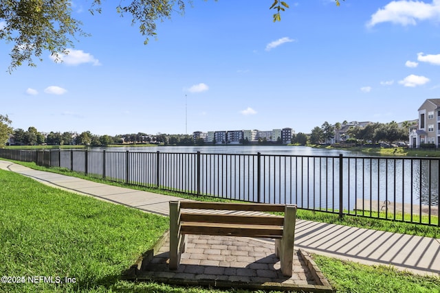 exterior space featuring a lawn and a water view