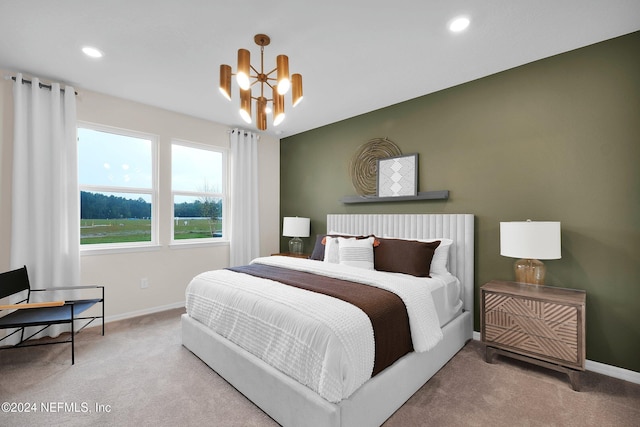 carpeted bedroom with an inviting chandelier