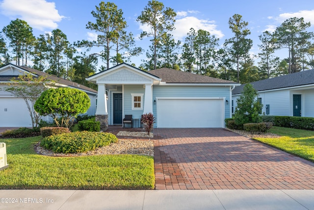 view of front facade with a front yard and a garage