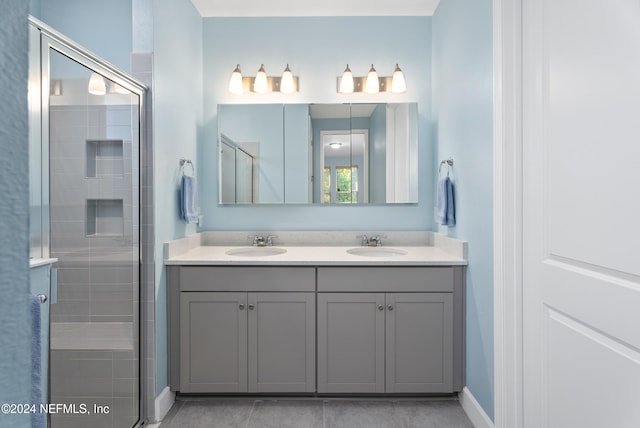 bathroom featuring tile patterned flooring, vanity, and walk in shower