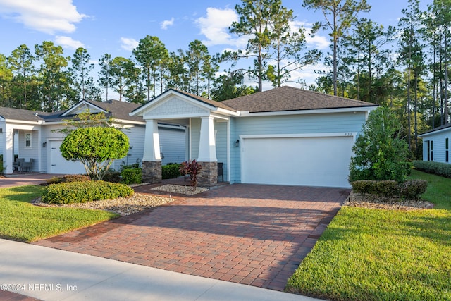 view of front of house featuring a garage and a front lawn