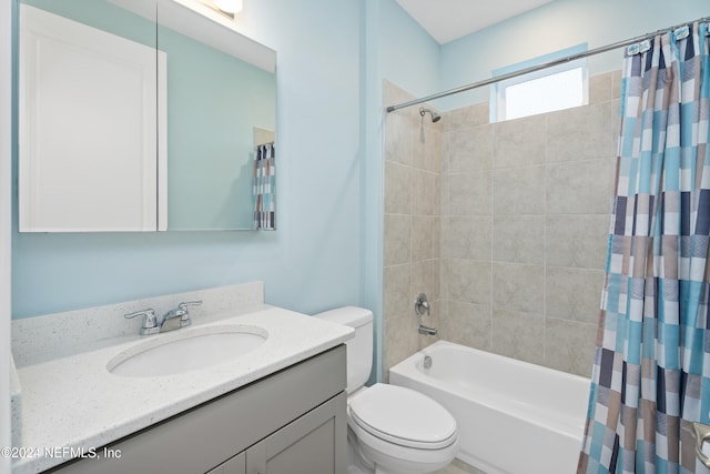 full bathroom featuring shower / bath combination with curtain, vanity, and toilet