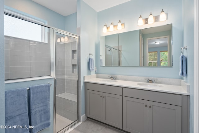 bathroom featuring vanity and a shower with shower door