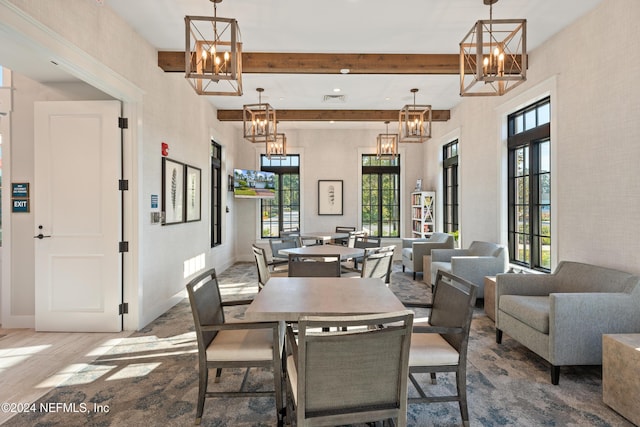 dining space with hardwood / wood-style floors, a wealth of natural light, and french doors