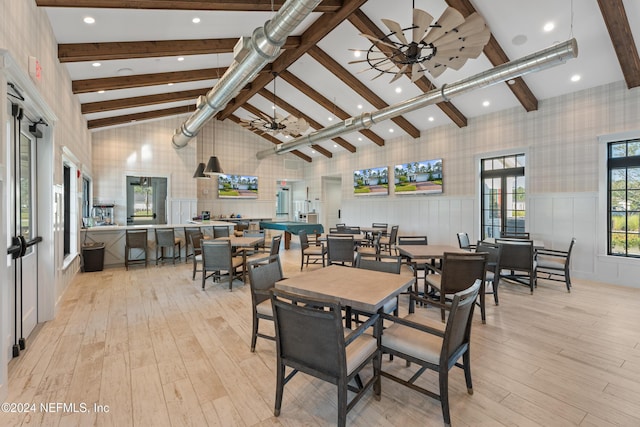 dining space featuring beam ceiling, light wood-type flooring, high vaulted ceiling, and ceiling fan