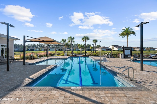 view of swimming pool featuring a patio area