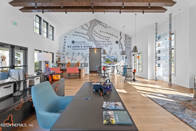 dining space featuring beamed ceiling, plenty of natural light, hardwood / wood-style floors, and high vaulted ceiling