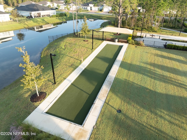 view of property's community with a yard and a water view